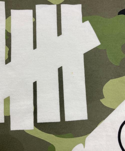 A BATHING APE（アベイシングエイプ）A BATHING APE (アベイシングエイプ) UNDEFEATED (アンディフィーテッド) プリントTシャツ ホワイト サイズ:XLの古着・服飾アイテム