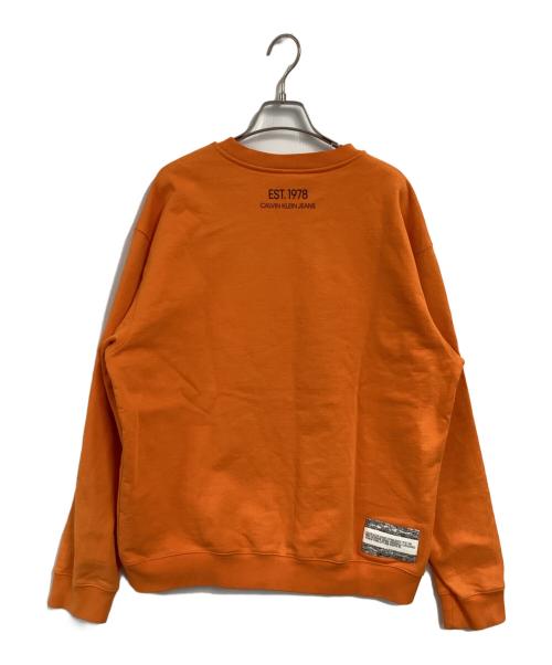 Calvin Klein Jeans（カルバンクラインジーンズ）Calvin Klein Jeans (カルバンクラインジーンズ) プリントスウェット オレンジ サイズ:Lの古着・服飾アイテム