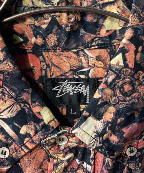 stussy（ステューシー）stussy (ステューシー) 宗教柄シャツ ブラック×オレンジ サイズ:Lの古着・服飾アイテム