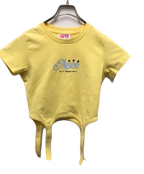 APEE by A BATHING APE（エーエイプ・バイ・ア・ベイシング・エイプ）APEE By A BATHING APE (エーエイプ・バイ・ア・ベイシング・エイプ) DRAPED STRAP GRAPHIC TOP イエロー サイズ:XSの古着・服飾アイテム