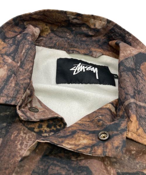 stussy（ステューシー）stussy (ステューシー) リアルツリーカモコーチジャケット ブラウン サイズ:Mの古着・服飾アイテム
