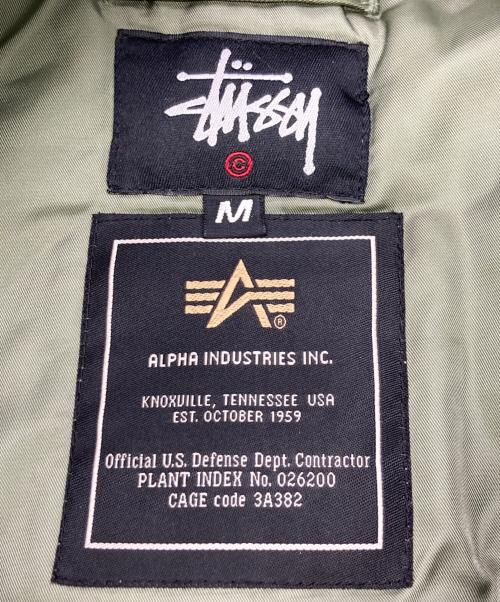 stussy（ステューシー）stussy (ステューシー) ALPHA (アルファ) FRAGMENT DESIGN (フラグメントデザイン) 25th Anniversary Ma-1 カーキ サイズ:Mの古着・服飾アイテム