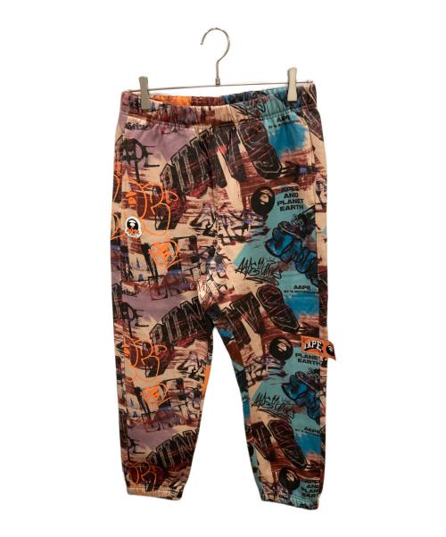 Aape BY A BATHING APE（エーエイプ バイ アベイシングエイプ）Aape BY A BATHING APE (エーエイプ バイ アベイシングエイプ) Moonface logo graffiti print jogger pants / グラフィックプリントスウェットパンツ ブラウン サイズ:Sの古着・服飾アイテム
