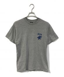 stussy（ステューシー）の古着「SURF MAN TEE」｜グレー
