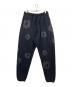 DENIM TEARS（デニムティアーズ）の古着「Wreath Sweatpants」｜ブラック