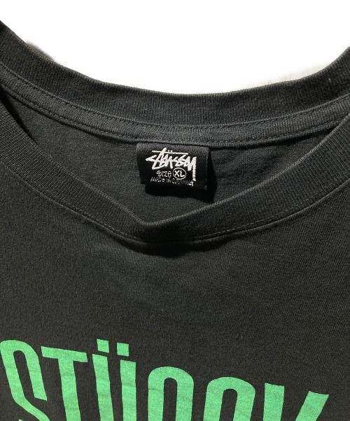 stussy（ステューシー）stussy (ステューシー) サーフマンTシャツ ブラック サイズ:XLの古着・服飾アイテム