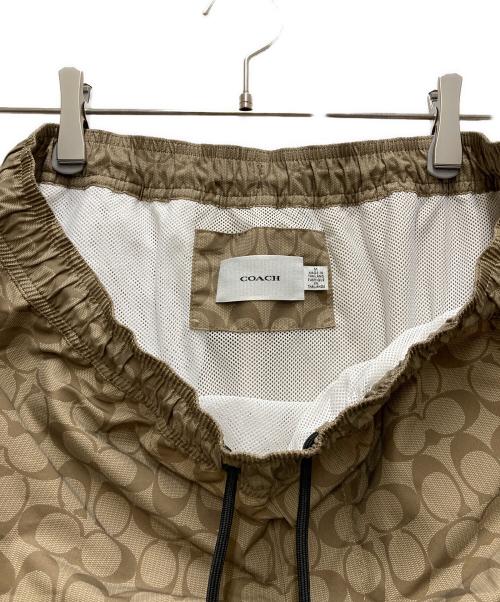 COACH（コーチ）COACH (コーチ) フェイデッド ブルー シグネチャー スイム トランクス ベージュ サイズ:Mの古着・服飾アイテム