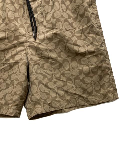 COACH（コーチ）COACH (コーチ) フェイデッド ブルー シグネチャー スイム トランクス ベージュ サイズ:Mの古着・服飾アイテム