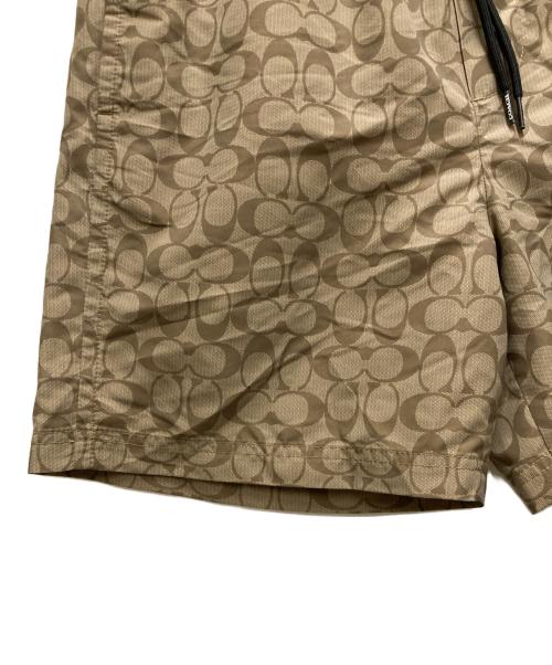 COACH（コーチ）COACH (コーチ) フェイデッド ブルー シグネチャー スイム トランクス ベージュ サイズ:Mの古着・服飾アイテム