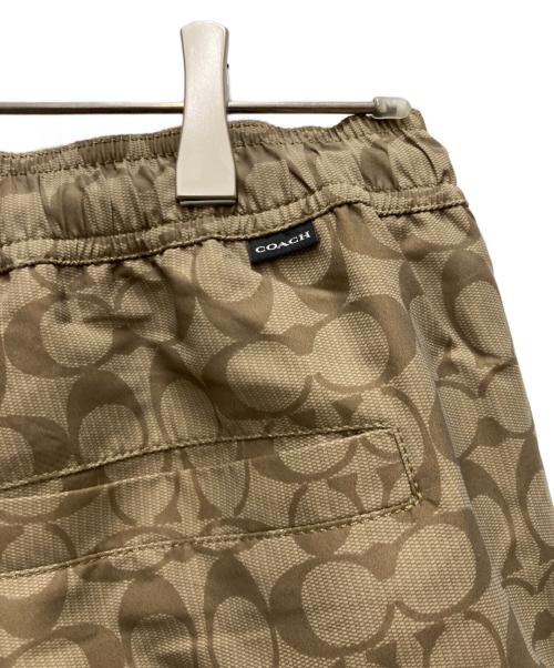 COACH（コーチ）COACH (コーチ) フェイデッド ブルー シグネチャー スイム トランクス ベージュ サイズ:Mの古着・服飾アイテム