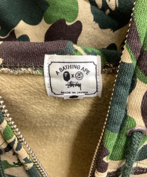 A BATHING APE（ア ベイシング エイプ）A BATHING APE (アベイシングエイプ) stussy (ステューシー) スカルサルカモジップパーカー / 30周年記念 / 10AW グリーン サイズ:Lの古着・服飾アイテム