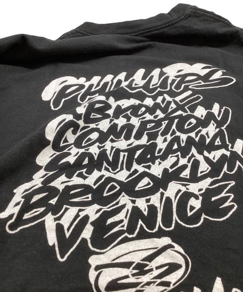 stussy（ステューシー）stussy  (ステューシー) WORLD TOUR TEE / ワールドツアーＴシャツ /  JIM PHILLIPS ブラック サイズ:XLの古着・服飾アイテム