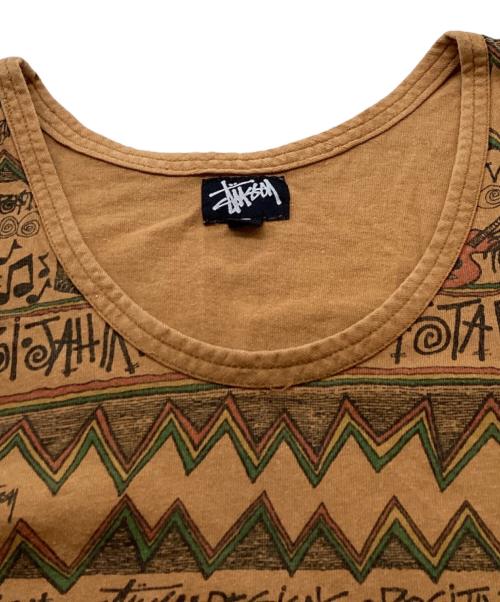 stussy（ステューシー）stussy (ステューシー) REGGAE TOMTOM 総柄タンクトップ / USA製 OLD ブラウン サイズ:Lの古着・服飾アイテム