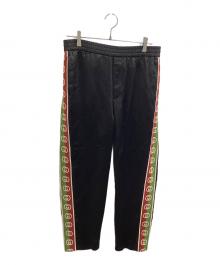 GUCCI（グッチ）の古着「サイド ロゴ ライン トラックパンツ」｜ブラック
