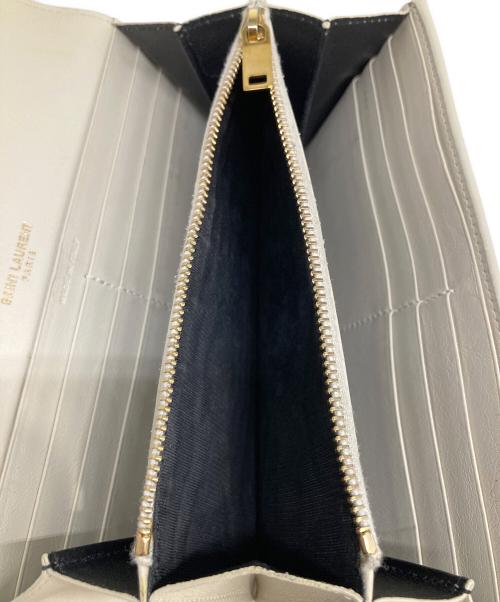 Yves Saint Laurent（イヴサンローラン）Yves Saint Laurent (イヴサンローラン) カサンドラYSLラージフラップウォレット アイボリーの古着・服飾アイテム