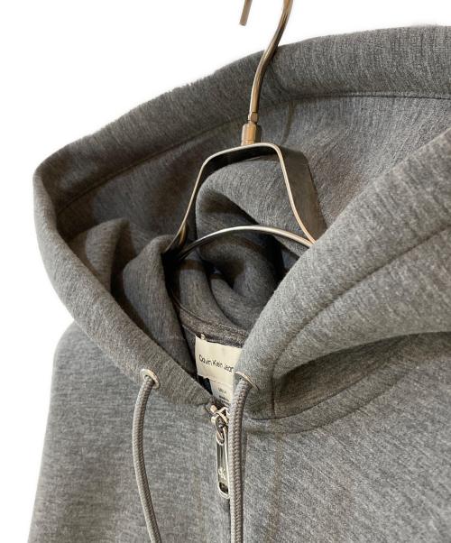 Calvin Klein Jeans（カルバンクラインジーンズ）Calvin Klein Jeans (カルバンクラインジーンズ) ジップアップ パーカー グレー サイズ:Ｓの古着・服飾アイテム