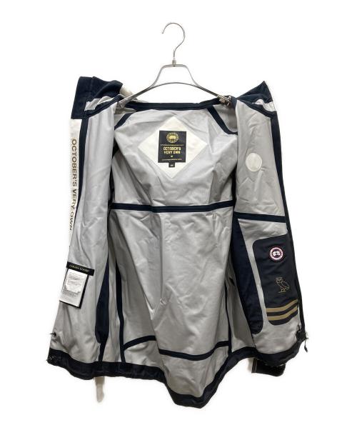 CANADA GOOSE（カナダグース）CANADA GOOSE (カナダグース) OCTOBERS VERY OWN(OVO) TIMBER SHELL x OVO シェルジャケット ホワイト サイズ:Mの古着・服飾アイテム