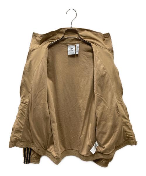 adidas（アディダス）adidas (アディダス) アディカラー ウーブン ファイヤーバード トラックトップ ベージュ×ブラック サイズ:XLの古着・服飾アイテム