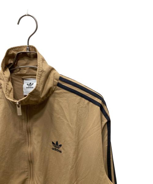 adidas（アディダス）adidas (アディダス) アディカラー ウーブン ファイヤーバード トラックトップ ベージュ×ブラック サイズ:XLの古着・服飾アイテム