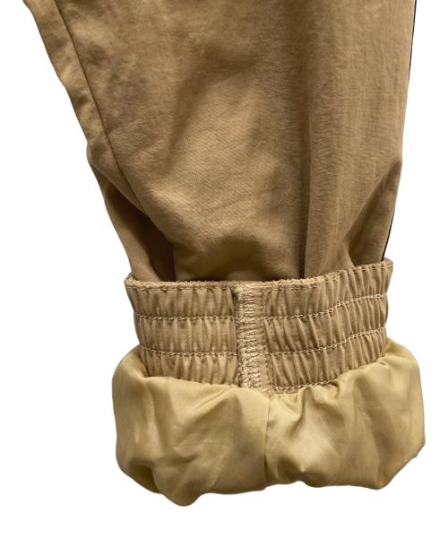 adidas（アディダス）adidas (アディダス) アディカラー ウーブン ファイヤーバード トラックトップ ベージュ×ブラック サイズ:XLの古着・服飾アイテム