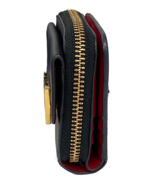 ANYA HINDMARCH（アニヤ・ハインドマーチ）ANYA HINDMARCH (アニヤハインドマーチ) ツイストリボンデザイン二つ折り財布 ブラックの古着・服飾アイテム