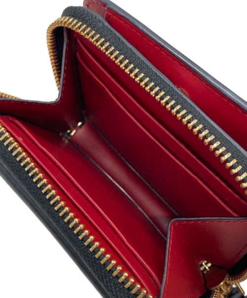 ANYA HINDMARCH（アニヤ・ハインドマーチ）ANYA HINDMARCH (アニヤハインドマーチ) ツイストリボンデザイン二つ折り財布 ブラックの古着・服飾アイテム