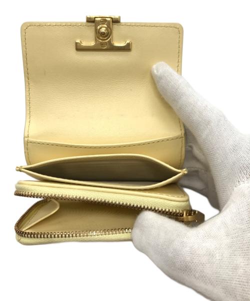 TOD'S（トッズ）TOD'S (トッズ) Tタイムレス2つ折り財布 イエローの古着・服飾アイテム