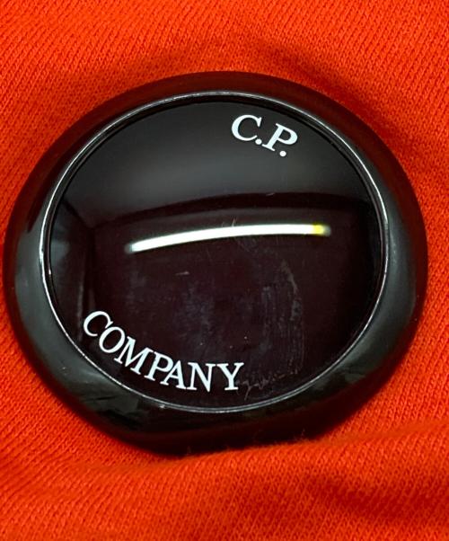 C.P COMPANY（シーピーカンパニー）C.P COMPANY (シーピーカンパニー) レンズアイコニック付きスウェットショートパンツ オレンジ サイズ:Ⅼの古着・服飾アイテム