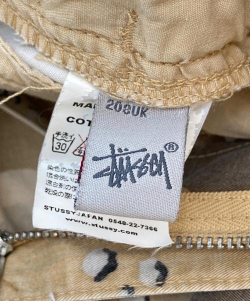 stussy（ステューシー）stussy (ステューシー) チョコチップカモフラ－ジュパンツ ベージュ×ブラウン サイズ:W32の古着・服飾アイテム