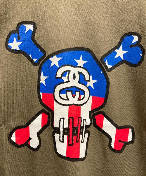 stussy（ステューシー）stussy (ステューシー) STARS AND STRIPES SKULL SS LOGO T / 星条旗SSロゴスカルTシャツ グリーン サイズ:XLの古着・服飾アイテム