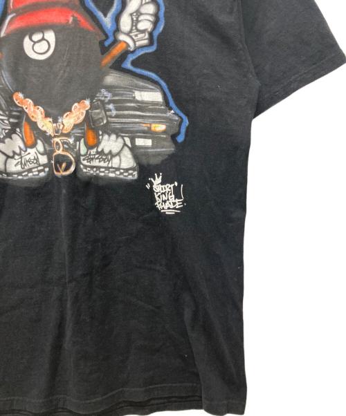 stussy（ステューシー）stussy (ステューシー) SHIRT KING PHADE (シャツキングフェイド) 8BALL MAN プリントTシャツ ブラック サイズ:XLの古着・服飾アイテム
