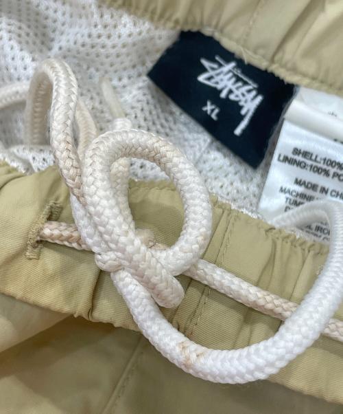 stussy（ステューシー）stussy (ステューシー) Sロゴナイロントラックパンツ ベージュ サイズ:XLの古着・服飾アイテム