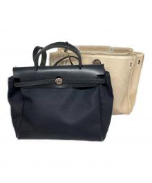 HERMES（エルメス）の古着「キャンバスバッグ」｜ベージュ×ブラック