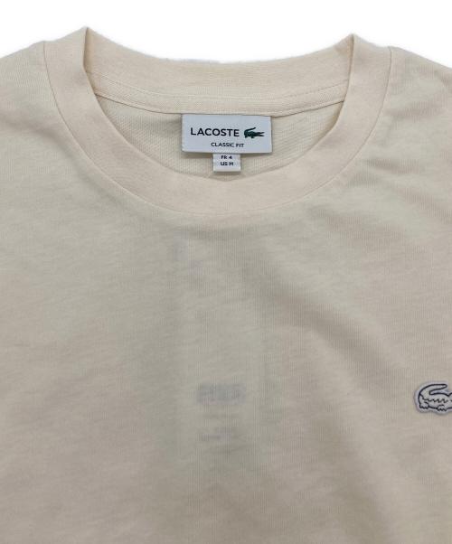 LACOSTE（ラコステ）LACOSTE (ラコステ) アウトライン クロック クルーネック Tシャツ ベージュ サイズ:SIZE M 未使用品の古着・服飾アイテム