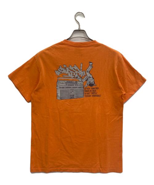 stussy（ステューシー）stussy (ステューシー) プリントTシャツ オレンジ サイズ:Mの古着・服飾アイテム