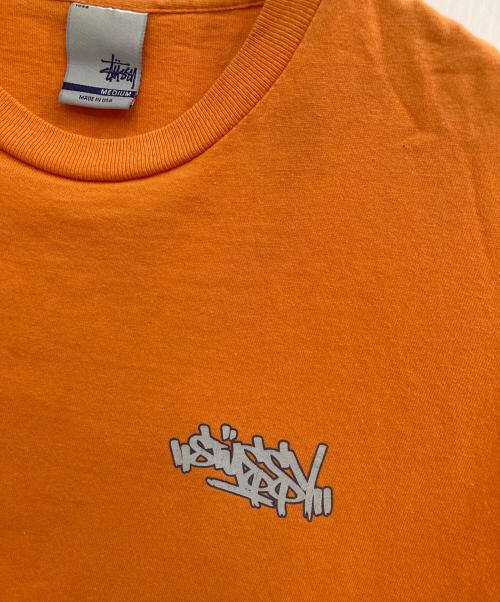 stussy（ステューシー）stussy (ステューシー) プリントTシャツ オレンジ サイズ:Mの古着・服飾アイテム