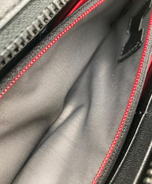 TUMI（トゥミ）TUMI (トゥミ) 長財布 ブラック×レッドの古着・服飾アイテム