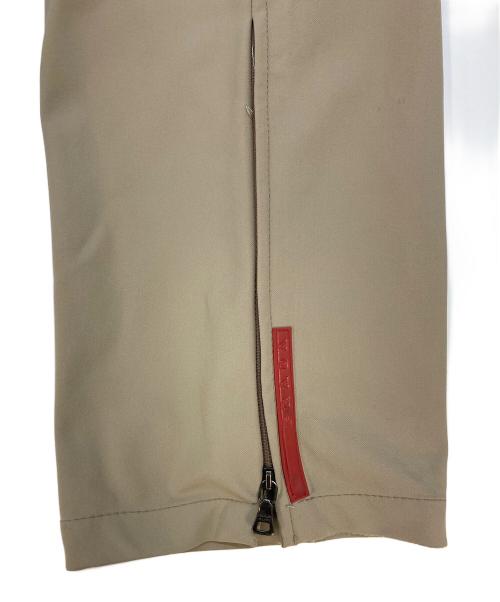 PRADA SPORTS（プラダスポーツ）PRADA SPORTS (プラダスポーツ) 裾ジップストレッチパンツ ベージュ サイズ:SIZE 48の古着・服飾アイテム