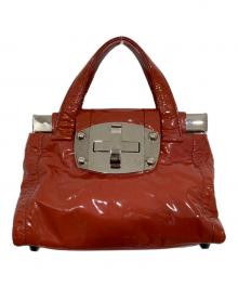 MIU MIU（ミュウミュウ）の古着「ターンロック エナメルハンドバッグ」｜朱色