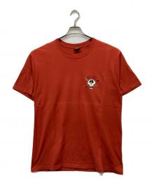 stussy（ステューシー）の古着「SURF SKATE SKULL TEE」｜オレンジ