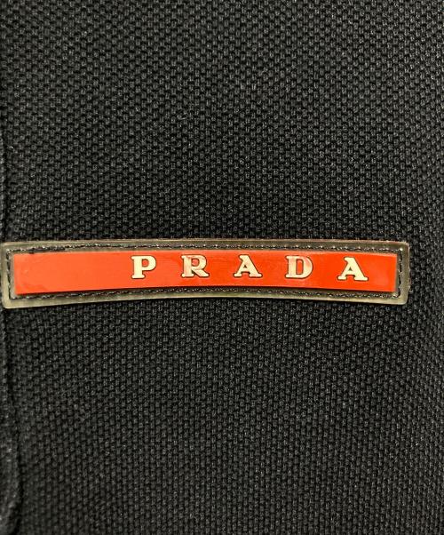 PRADA SPORTS（プラダスポーツ）PRADA SPORTS (プラダスポーツ) ロゴプレート 鹿の子ポロシャツ ネイビー サイズ:Mの古着・服飾アイテム