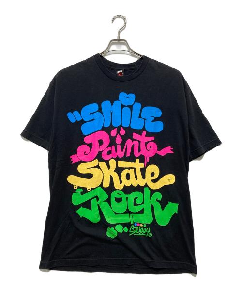 stussy（ステューシー）stussy (ステューシー) SMILE PAINTE SKATE ROCK TEE スマイルペイントスケートロックTシャツ ブラック サイズ:XLの古着・服飾アイテム