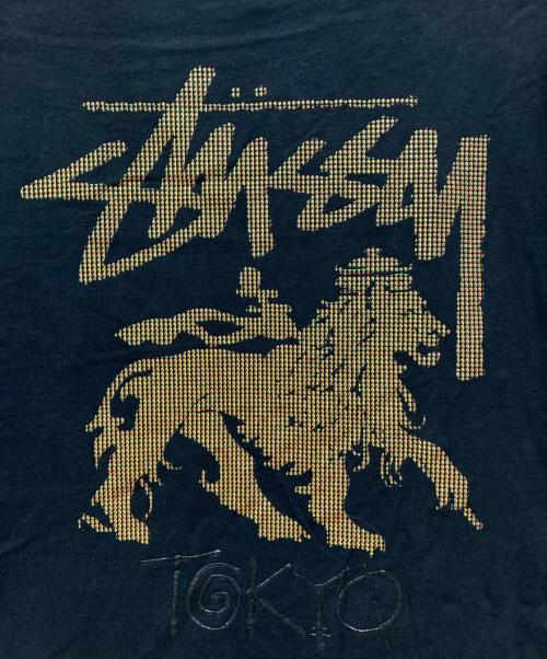 stussy（ステューシー）stussy (ステューシー) ラスタフラッグTシャツ ブラック サイズ:XLの古着・服飾アイテム