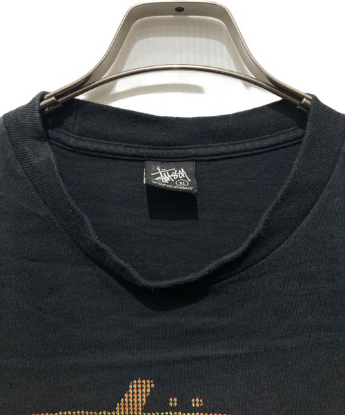 stussy（ステューシー）stussy (ステューシー) ラスタフラッグTシャツ ブラック サイズ:XLの古着・服飾アイテム
