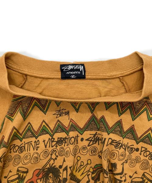 stussy（ステューシー）stussy (ステューシー) ラスタ総柄 ラグラン カットソー ブラウン サイズ:XLの古着・服飾アイテム