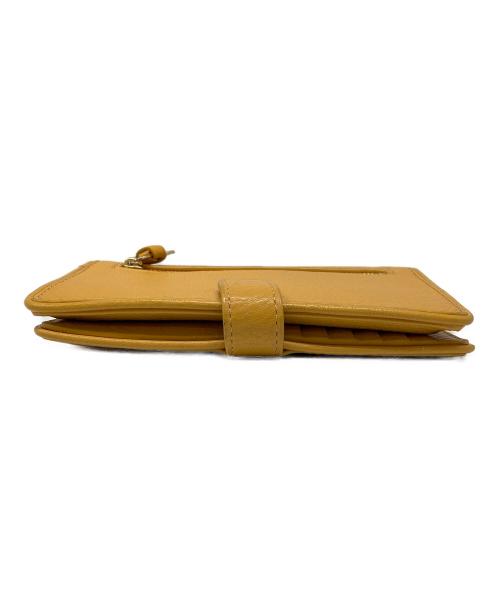 TORY BURCH（トリーバーチ）TORY BURCH (トリーバーチ) スマートフォンウォレットポーチ イエローの古着・服飾アイテム