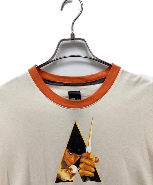 glamb（グラム）glamb (グラム) KUBRICK (キューブリック) ムービーリンガーTシャツ オレンジの古着・服飾アイテム