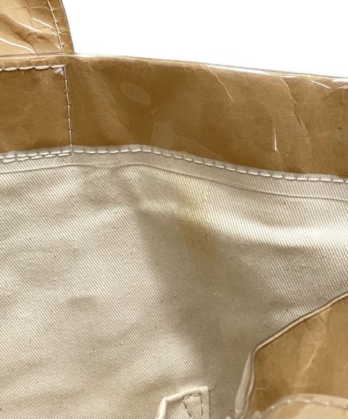 COMME des GARCONS（コムデギャルソン）COMME des GARCONS (コムデギャルソン) PVCペーパーロゴトートバッグ ベージュの古着・服飾アイテム