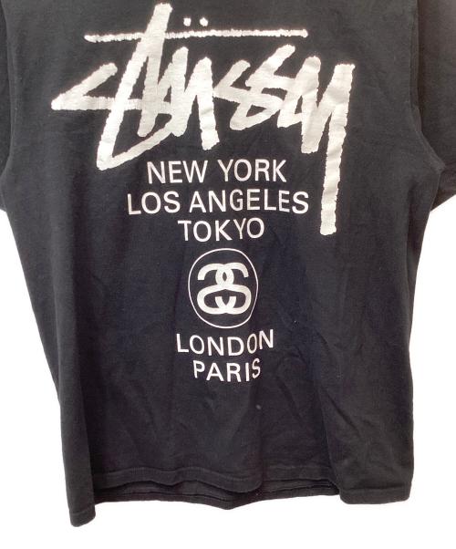 stussy（ステューシー）stussy (ステューシー) World tour tee（ワールドツアーティー） ブラック サイズ:Mの古着・服飾アイテム
