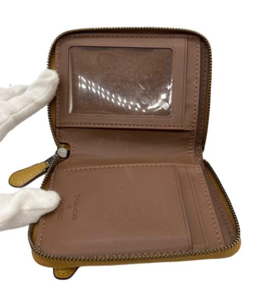 COACH（コーチ）COACH (コーチ) PEANUTS (ピーナッツ) ラウンドジップウォレット イエローの古着・服飾アイテム